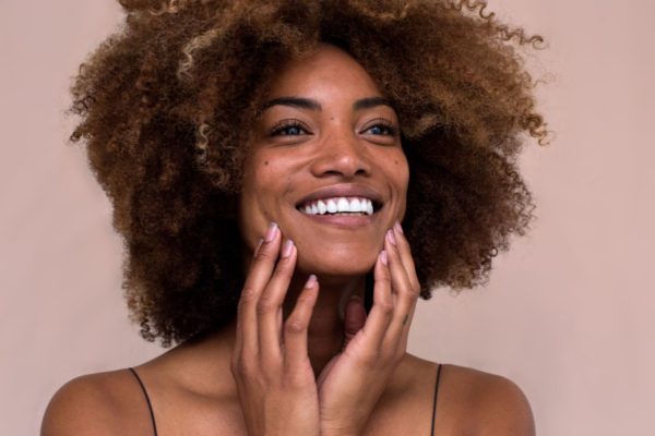 woman applying moisturizer